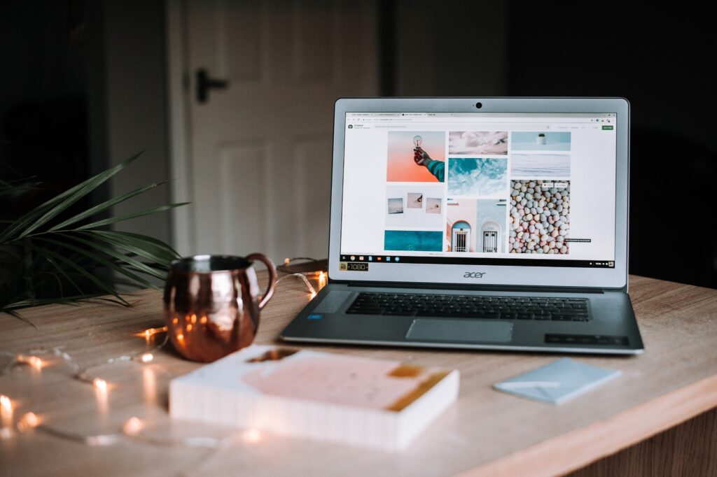 A laptop, a book, lights on the table