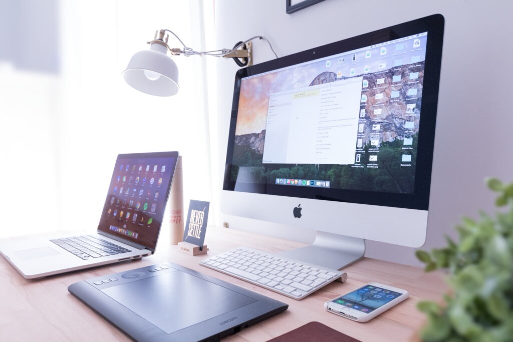 Desktop, Laptop, Phone on a table