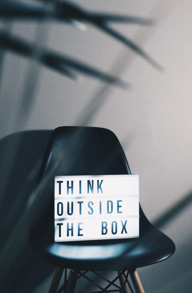 A chair with a poster saying 'Think outside the box'